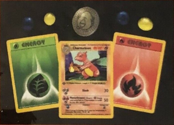 Middle card in the in front of the two energy cards with damage counters